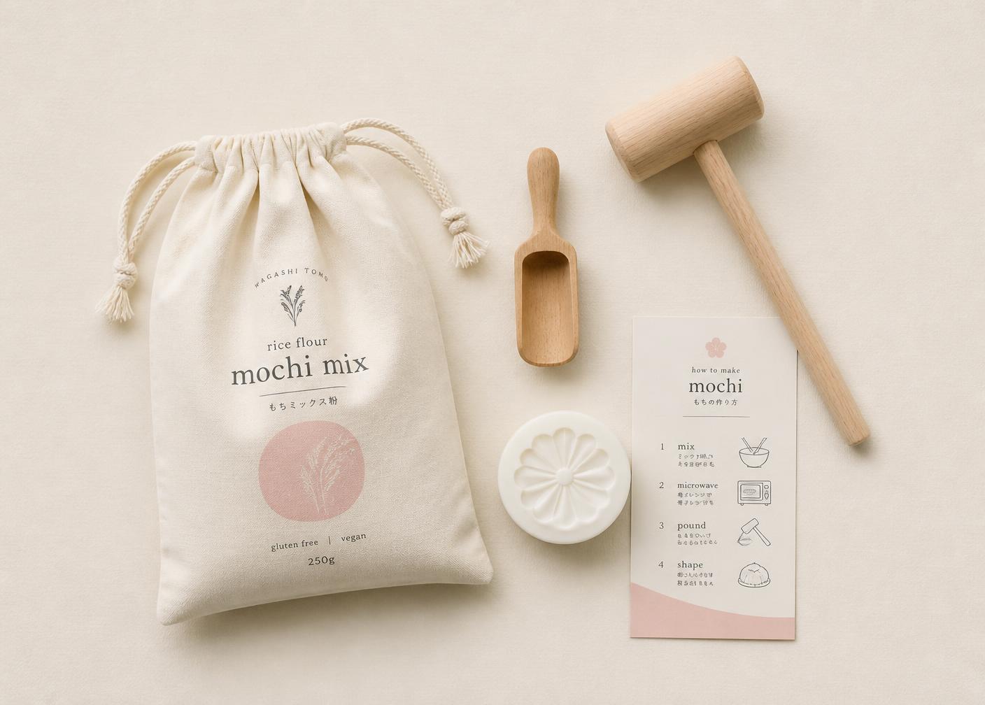Flat lay of the MOCHI LAB kit contents: mochi mix pouch, wooden tools, mold and guide card